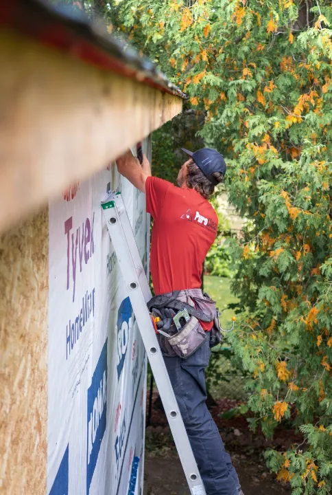 Carpenter cutting timber