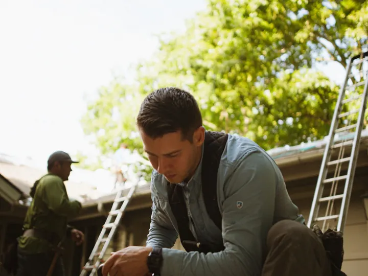 Two-person crew working on a roofline