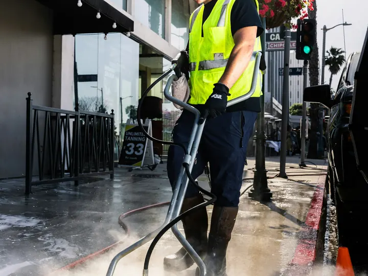 Pro pressure-washing a walkway