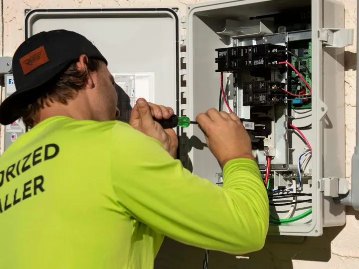 Electrician wiring a service panel