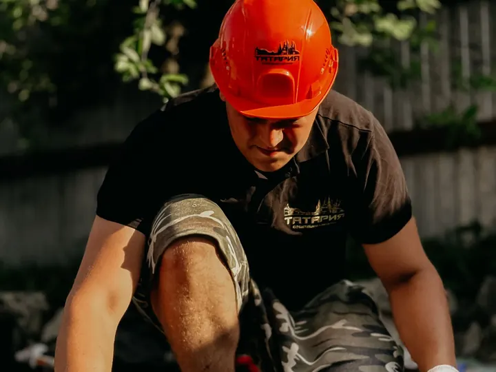 Pro kneeling over a job